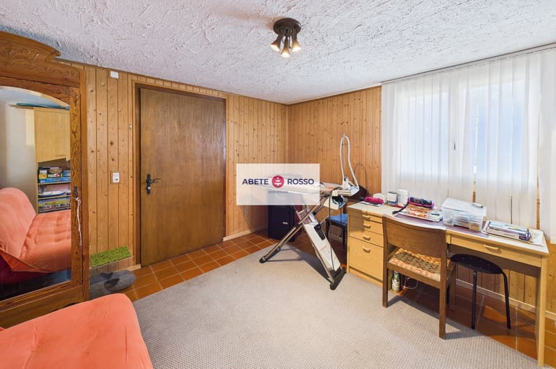 wooden walls, wooden door, wooden desk, wooden chair, carpet, iron board, books, mirror