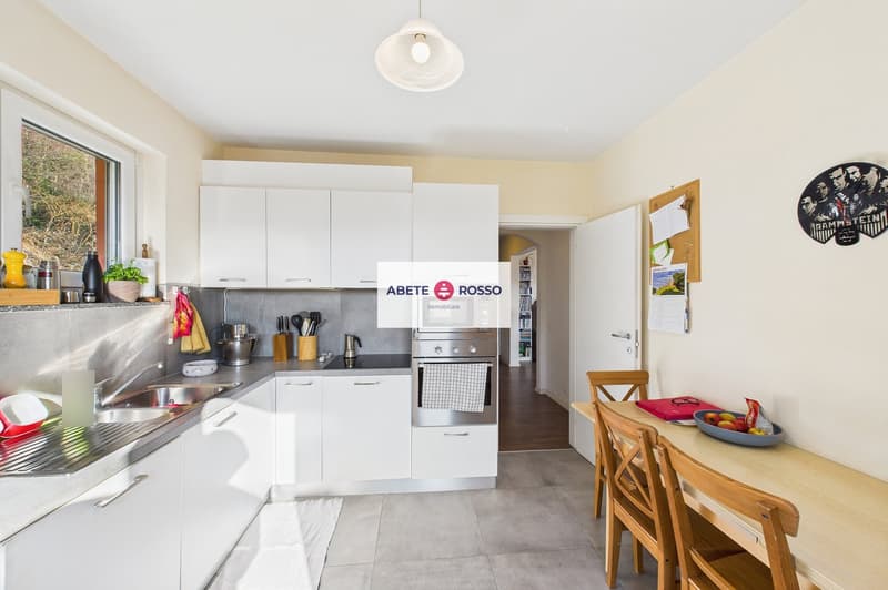 modern kitchen, white cabinets, stainless steel appliances, granite countertops, dishwasher, washing machine, large window