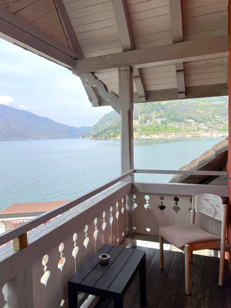 chair and table, wood floor, scenic view of the mountains and the lake