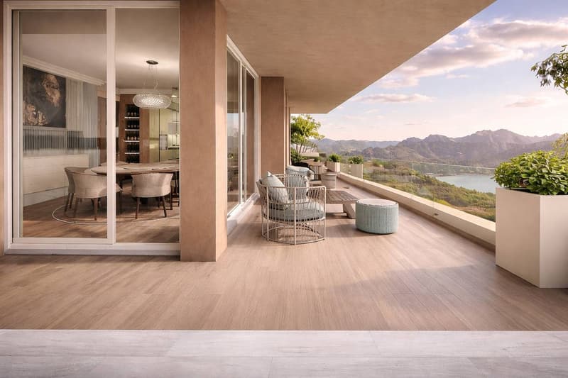 modern balcony with wooden floor, glass walls, outdoor furniture, dining table, view of mountains and lake
