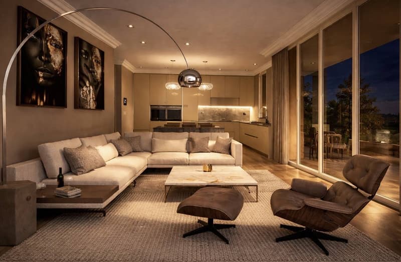 modern living room, large windows, large sofa, coffee table, two armchairs, floor lamp, carpet, wine bottle, books, wine glasses