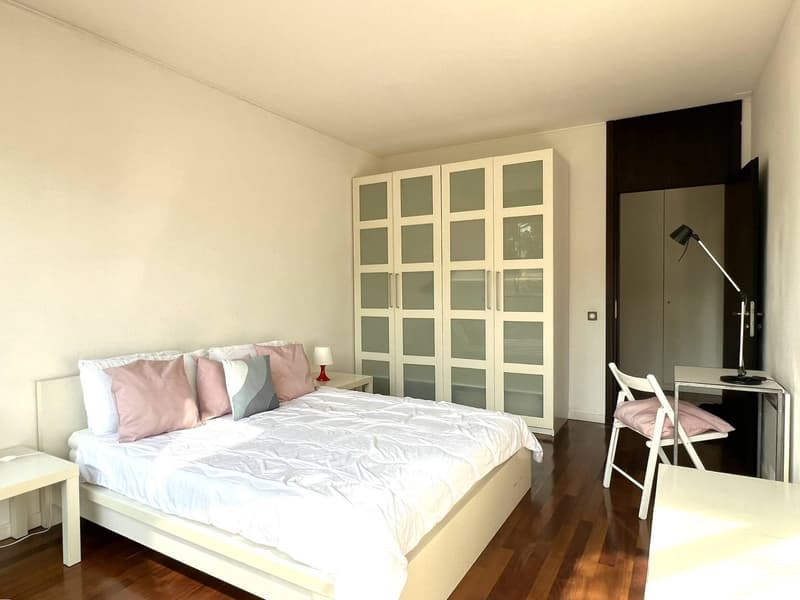 Bedroom with a bed, nightstands, wardrobe, desk, and chair
