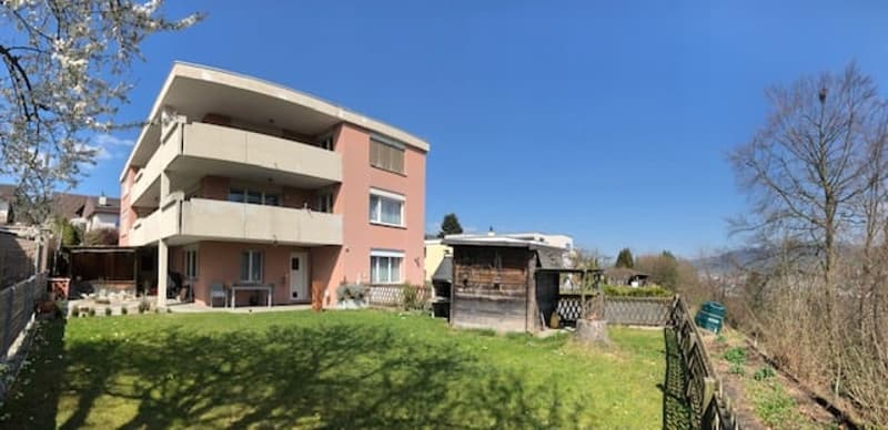 3 story house, pink exterior, balcony, garden, shed
