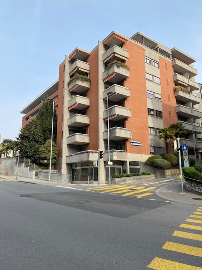 residential building with balconies, orange exterior, modern architecture