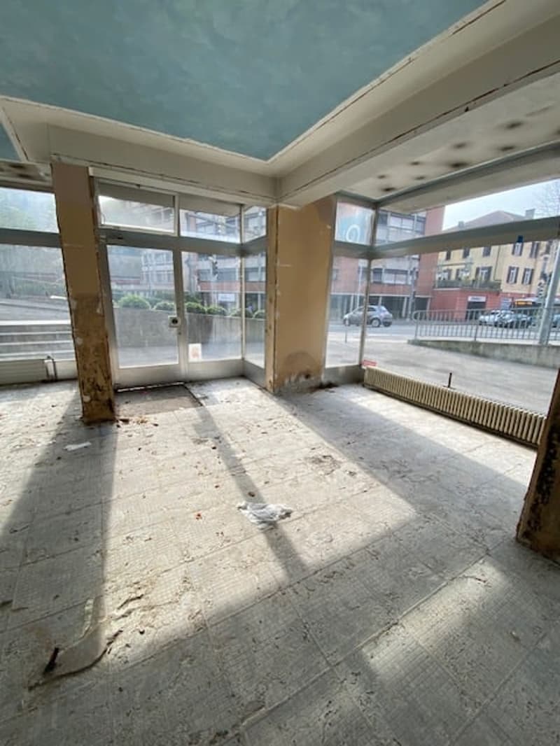 tiled floor, glass doors, windows, unfinished ceiling, city street view