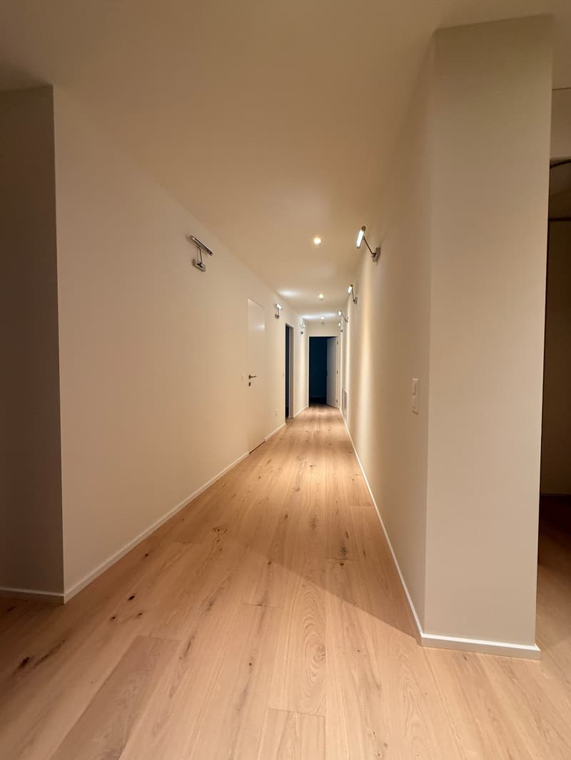 White walls, wooden floor, two doors