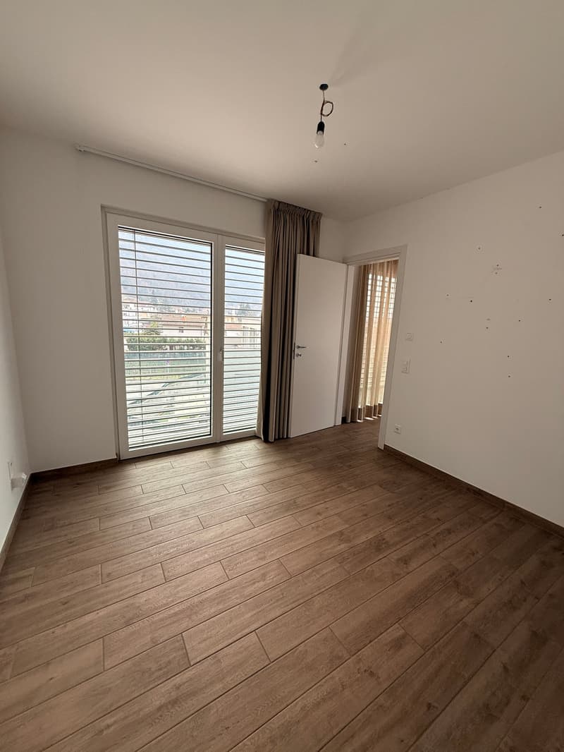 empty room, large windows, wooden floor, curtains