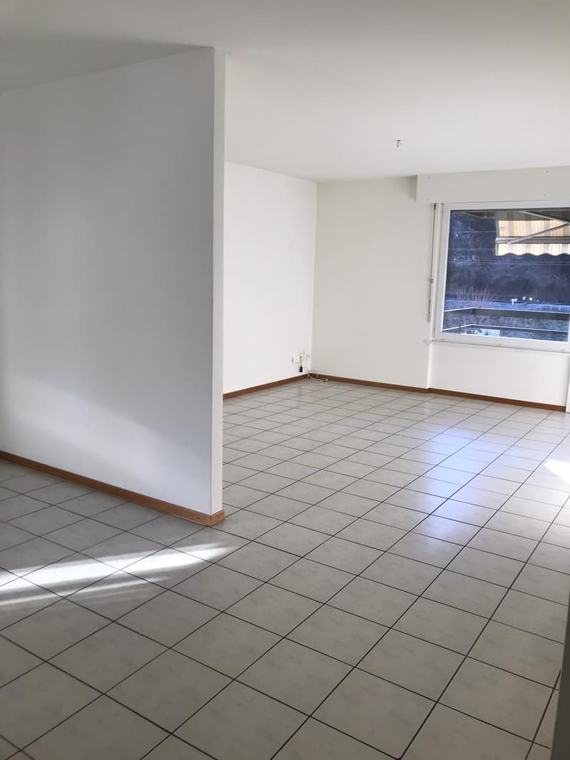 empty room, white tiled floor, white walls, power outlet, large window with balcony view