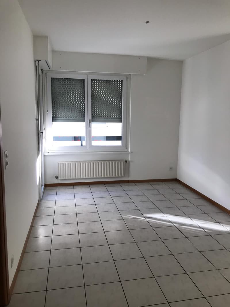 tiled floor, white walls, white radiator, double window, door, empty room
