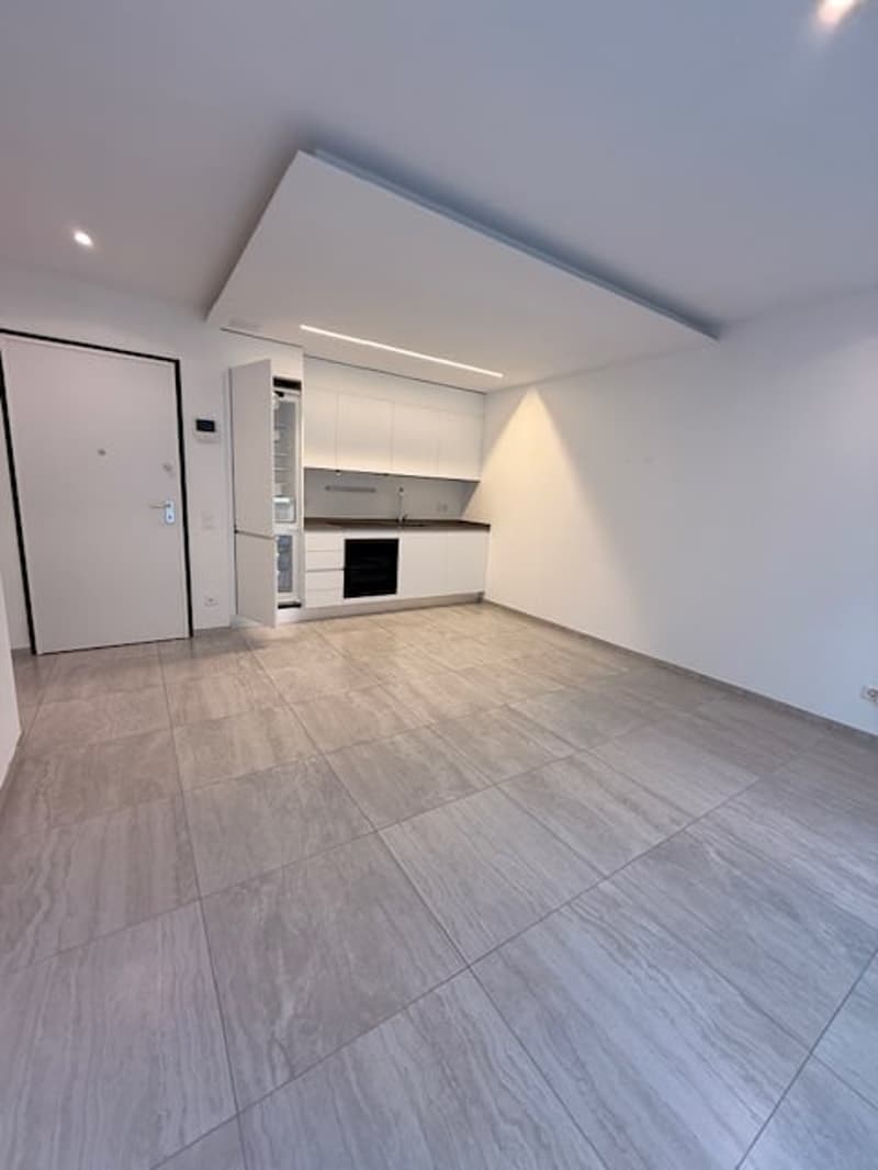 Modern kitchen with white cabinets, granite countertop, and built-in oven and microwave