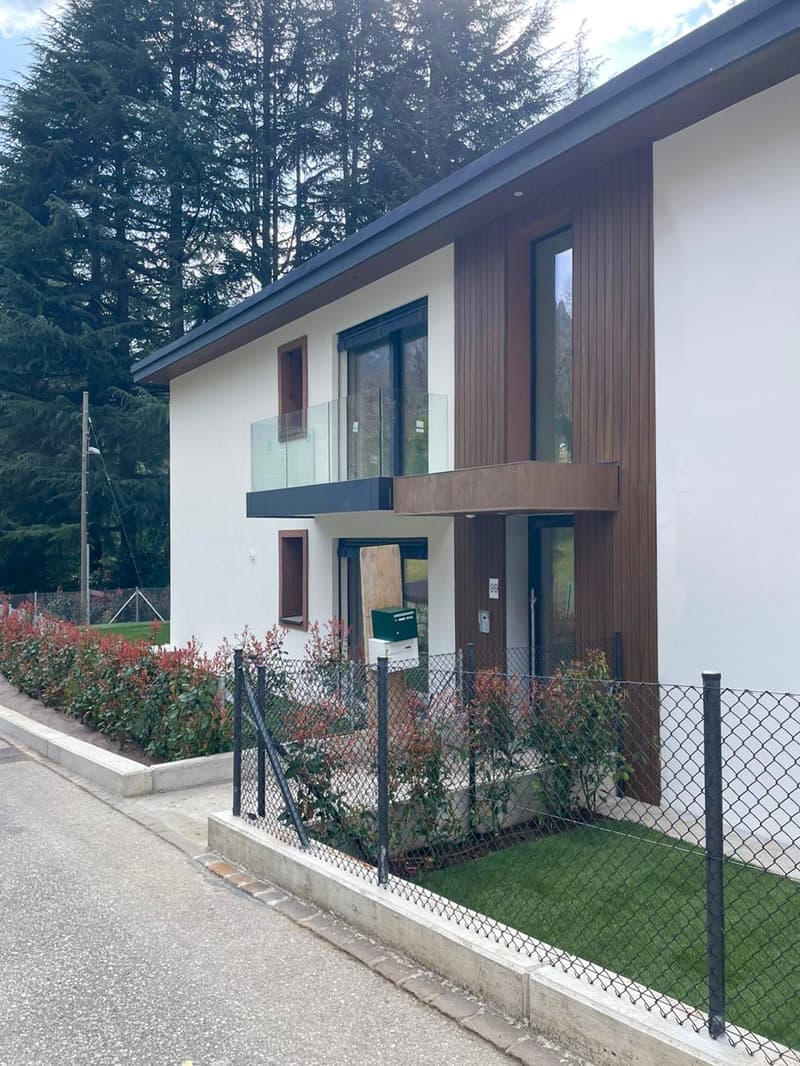 modern house, white and brown exterior, glass balcony, fenced garden, street view