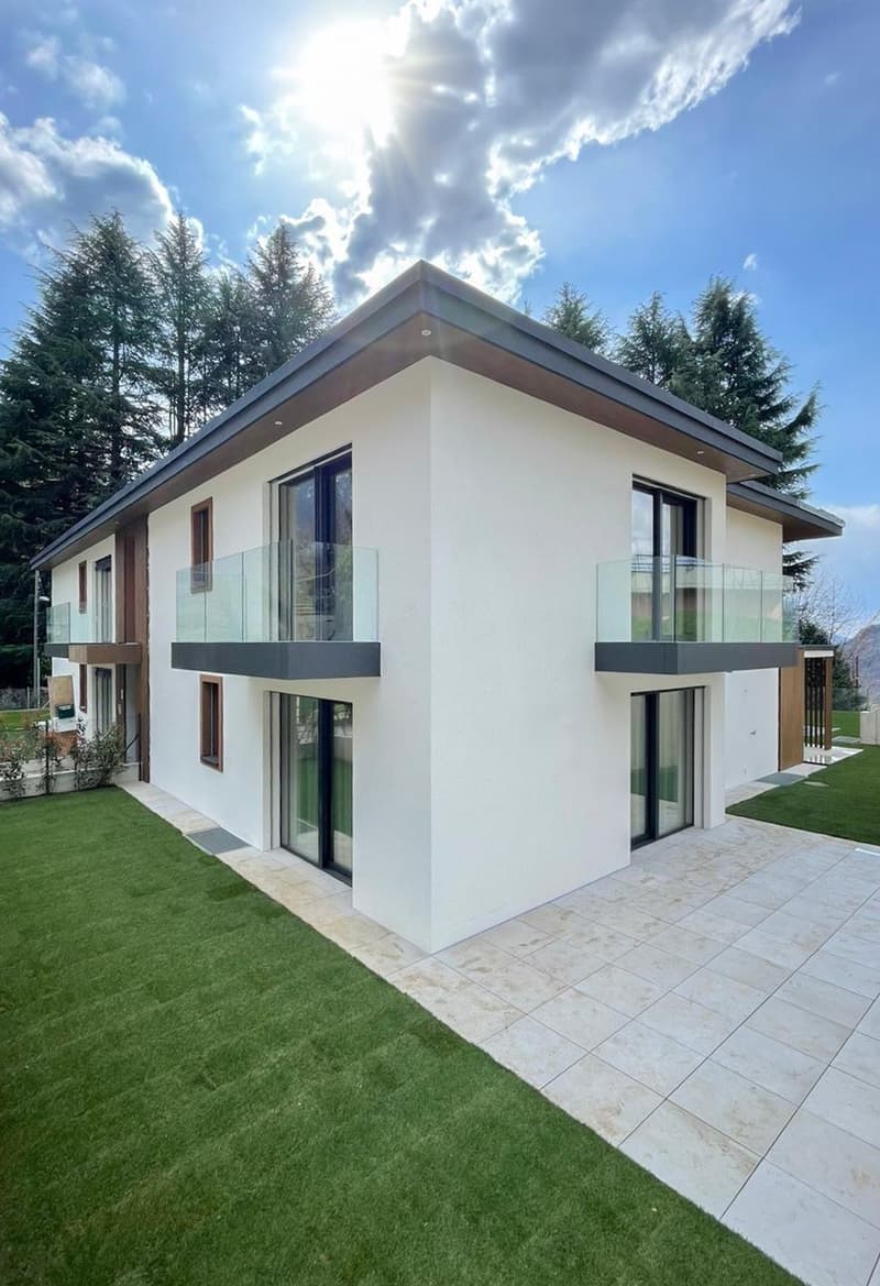 modern white house, glass balconies, large windows, tiled patio, well-manicured lawn