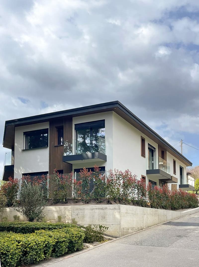 modern 2-story house, white and brown exterior, large windows, balconies, concrete wall, greenery