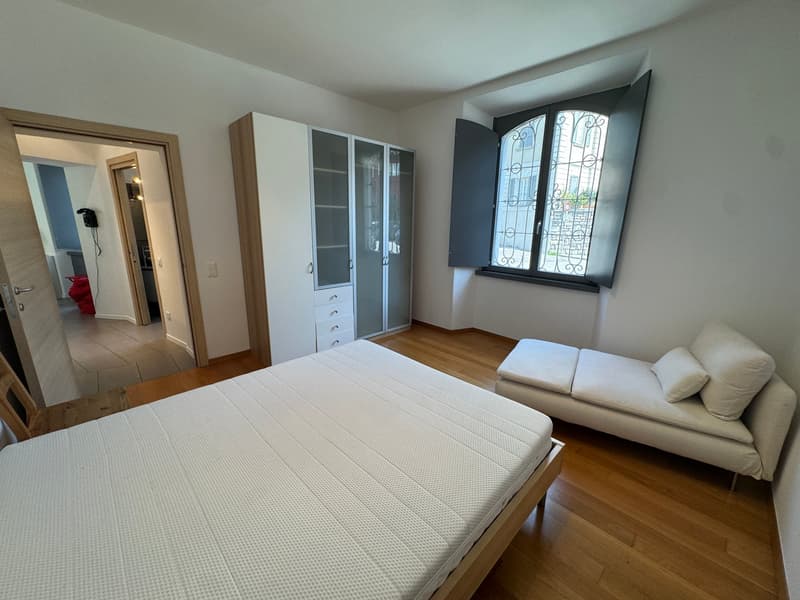 bedroom with bed, daybed, wardrobe, window with view