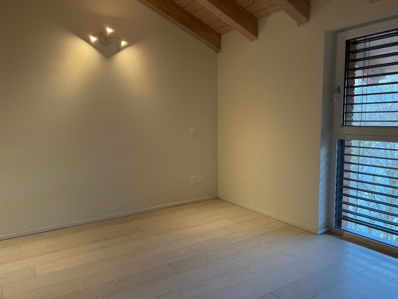 Modern attic with rooftop view for sale in Cadro - PARKING SPACE (5)