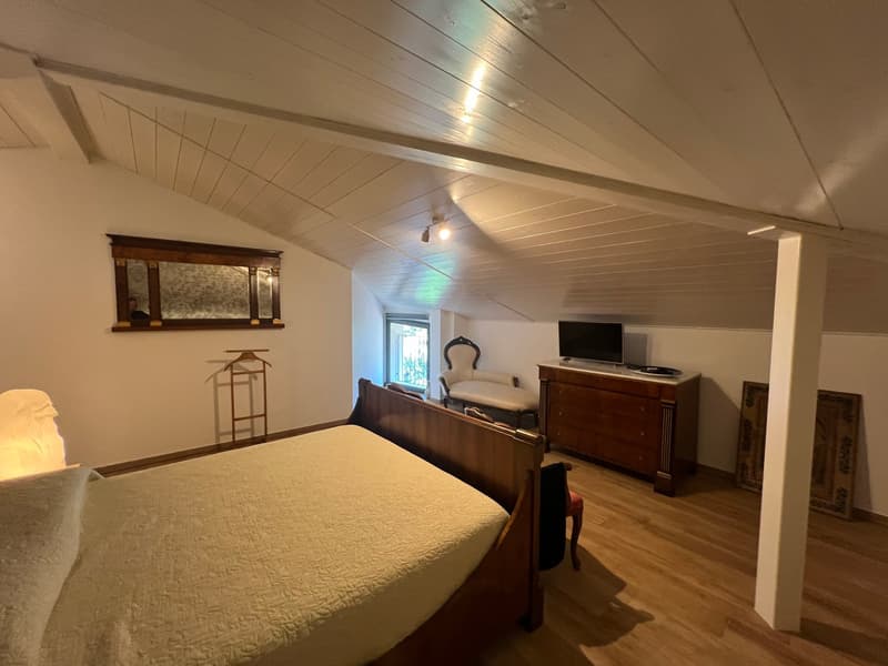 wooden bed, wooden cabinet, TV, chair, mirror, wooden floor, white walls