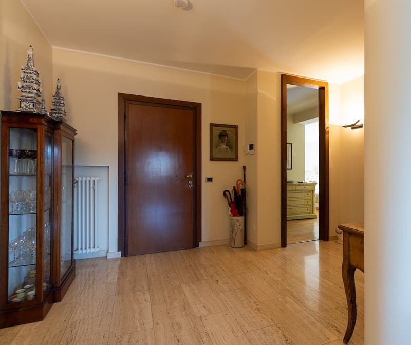 wooden floor, wooden door, glass cabinet, radiator, umbrella stand, picture frame, mirror, wooden table