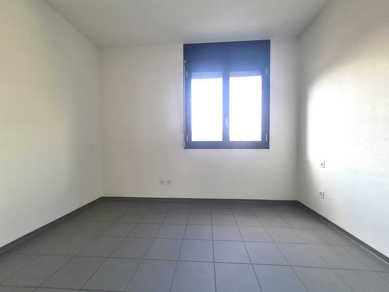 empty room, white walls, tiled floor, window with shutters, power outlets
