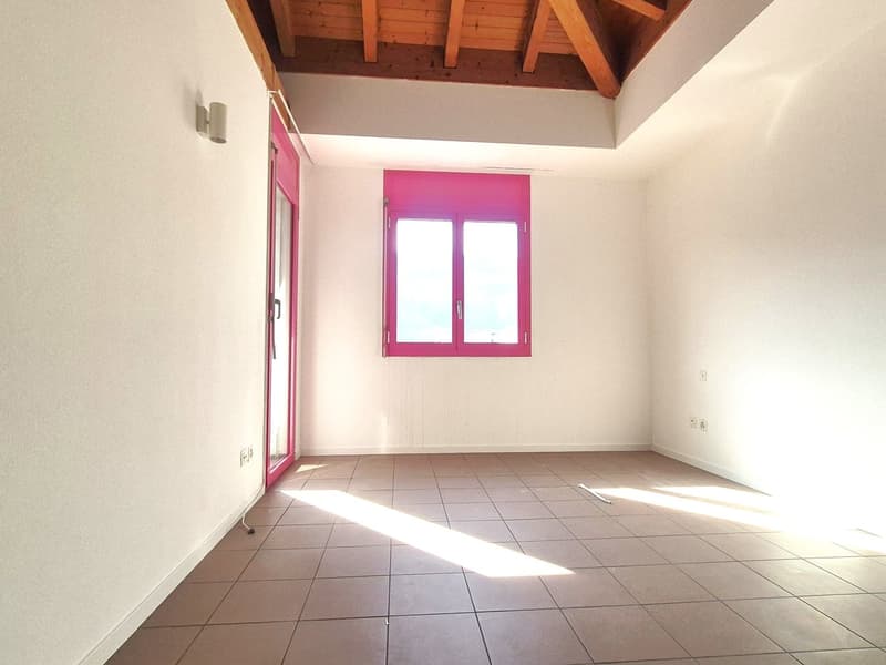 empty room with tiled floor, large window with pink frame, door with pink frame, wooden ceiling