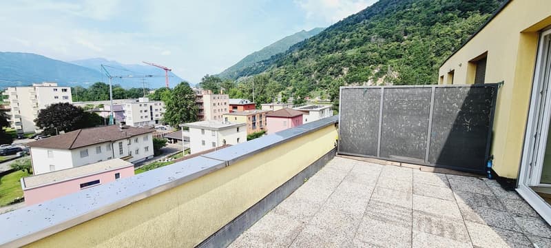 Terrace with a city view and mountain background