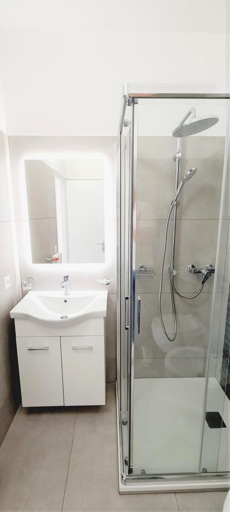 modern bathroom, with white sink, a shower and a mirror