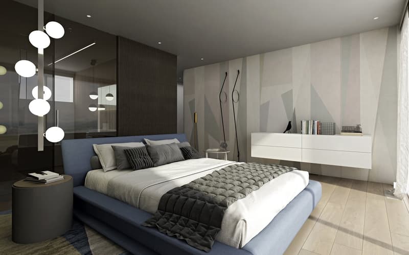 modern bedroom with a large bed, blue headboard, white and grey bedding, nightstand, white cabinet, decorative items, and a glass wall