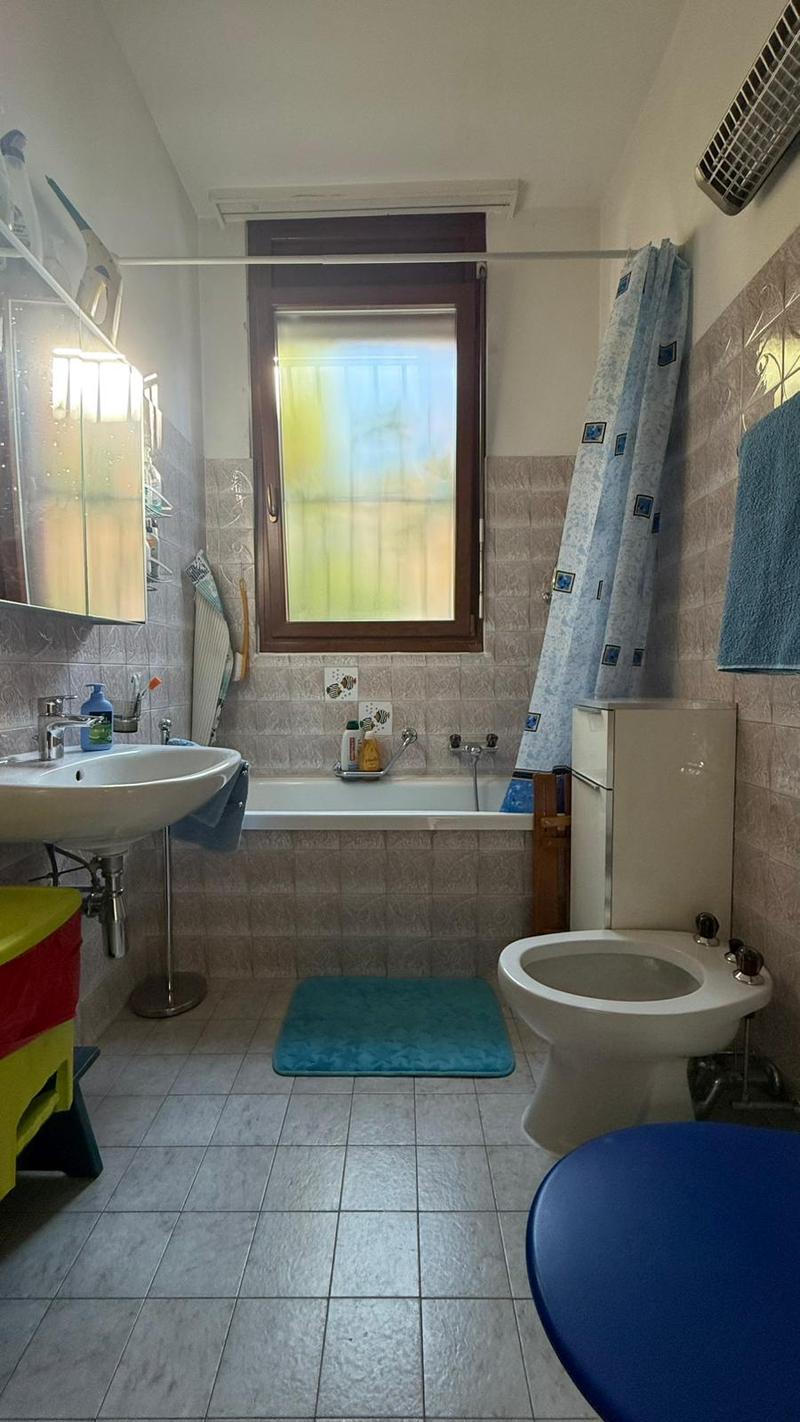 Bathroom with a sink, toilet, bathtub and window