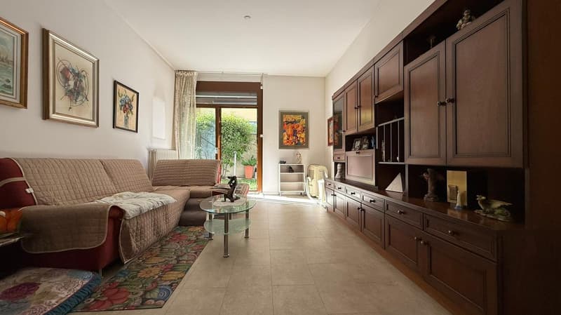 living room with couches, coffee table, carpet, wooden shelves, pictures, terrace
