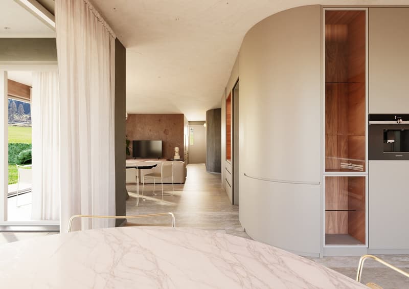 Modern interior, large hallway, curved wooden wall, white and brown marble, dining table, chairs, and kitchen area with appliances