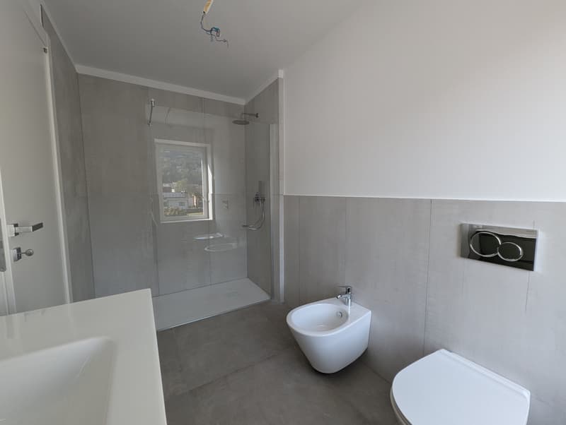 modern bathroom with shower, bidet, toilet, and sink