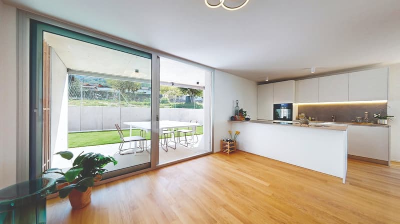 modern kitchen with dining area, large sliding glass doors, wooden floor, view of the garden