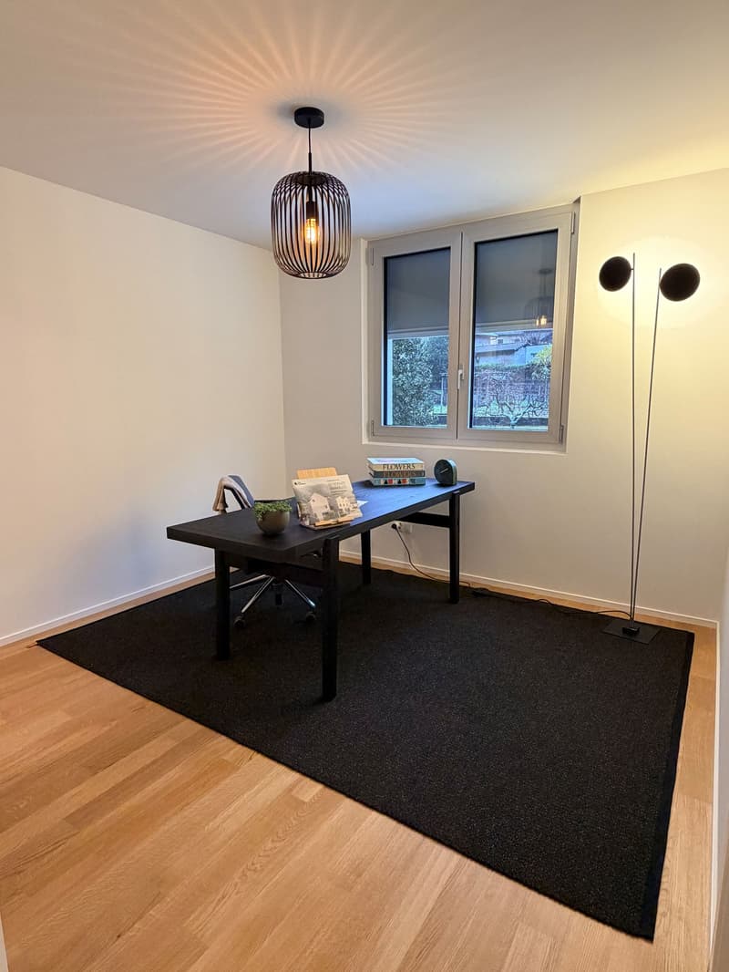 Office room: desk, chair, books, floor lamp, wall light, carpet