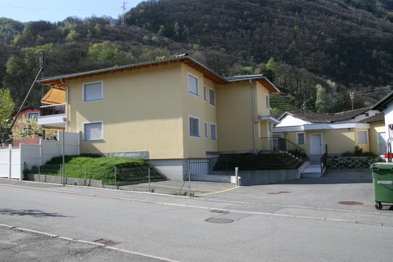2 story house, yellow exterior, balcony, fenced yard, mountain view