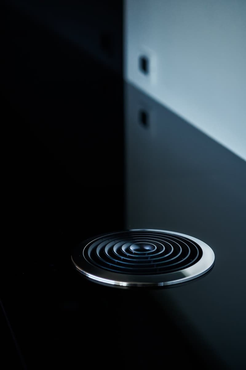 Stainless steel induction cooktop with a circular burner pattern.