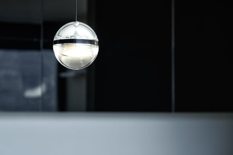 Clear spherical pendant light, modern design, suspended from ceiling, illuminated from within