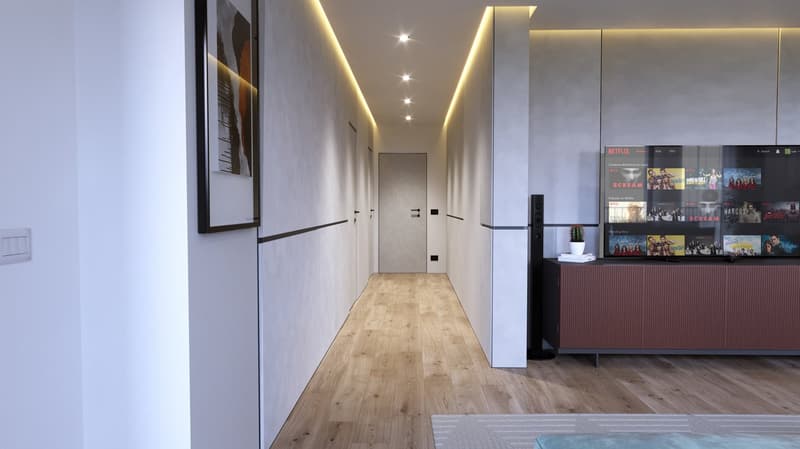 Long, well-lit hallway with wooden flooring, white walls, and recessed lighting. A Netflix display unit is visible at the end of the hallway.