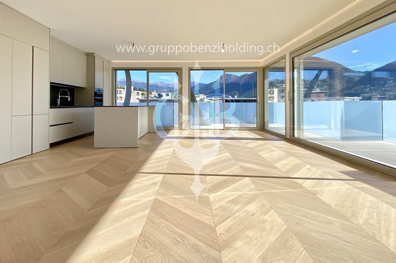 modern open plan kitchen with large glass doors to balcony, wooden parquet floor, large windows to outside