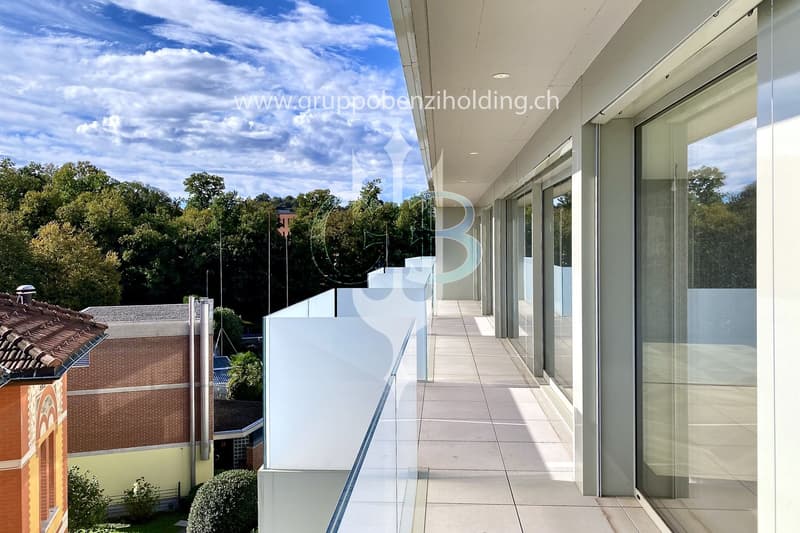 glass balcony, glass wall, tiled floor, view of trees and blue sky