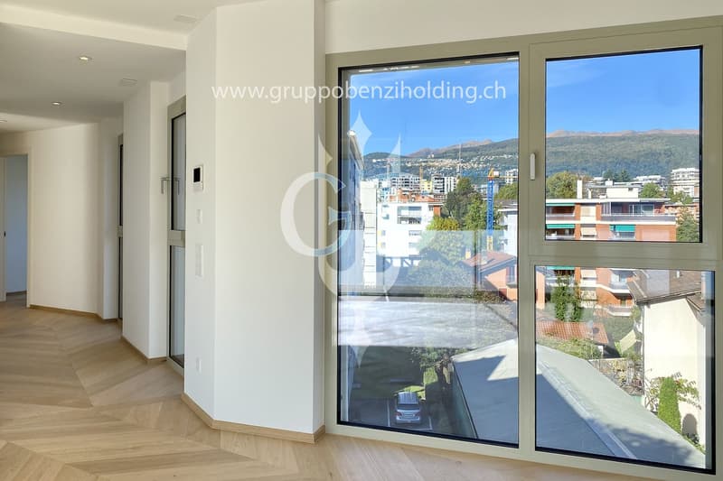 large window with a beautiful view of the mountains and cityscape, wooden parquet floor, contemporary design