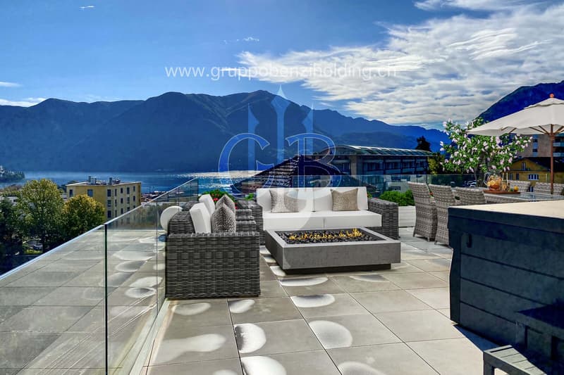 balcony, white wicker sofas, outdoor fireplace, umbrella, dining table, scenic mountain view