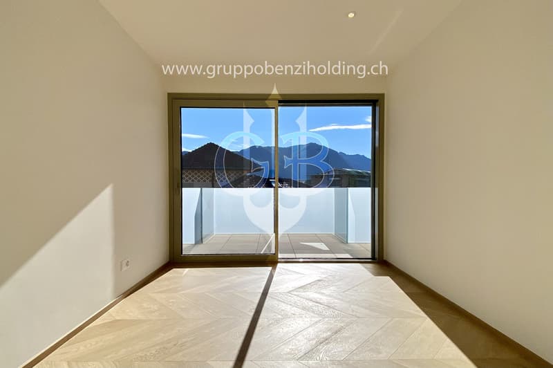 An open balcony with sliding glass doors, wooden floors, and modern architecture