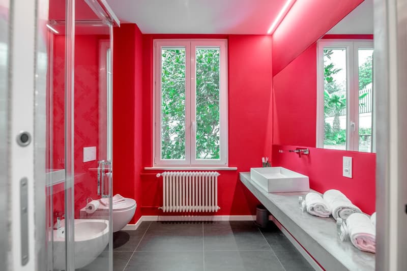 bathroom, red walls, white fixtures, sink, radiator, toilet, walk-in shower, towels