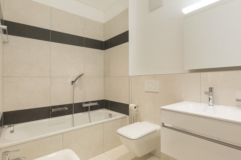 modern bathroom, bathtub, shower head, toilet, sink, floor and wall tiles