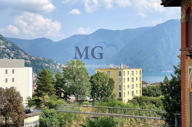 Building with mountains, sea and lake in the background.