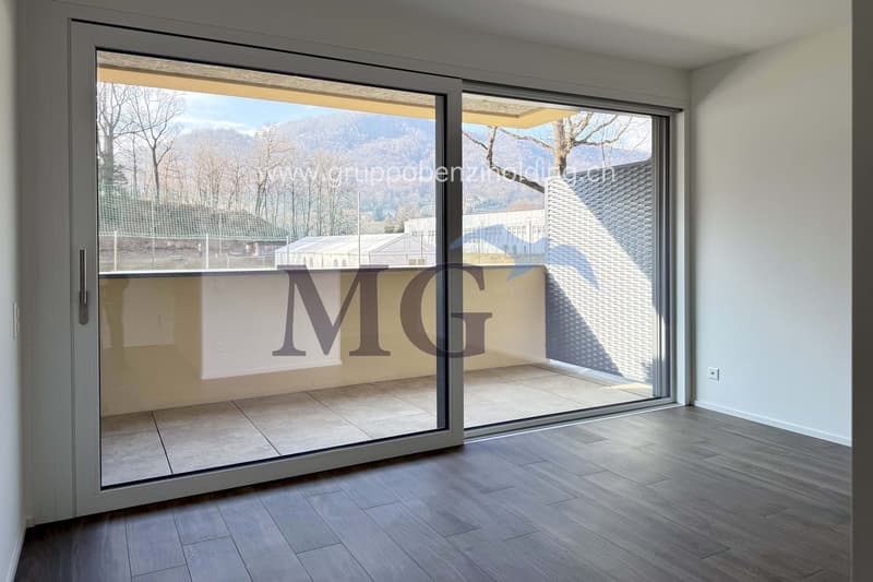 open space with sliding doors leading to balcony, tiled floor, panoramic view of mountains