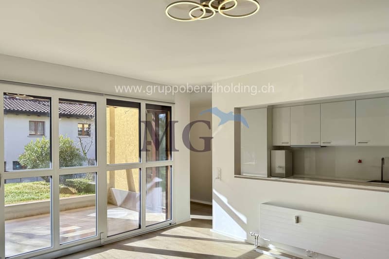 modern kitchen, white cabinets, open floor plan, glass sliding doors, wooden floor