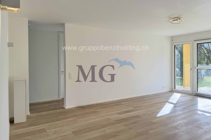 Empty room with sliding doors leading to balcony