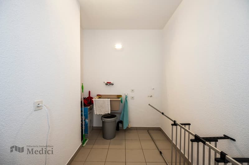 small room with washing sink, towel, garbage bin, broom, towel bar, metal bar