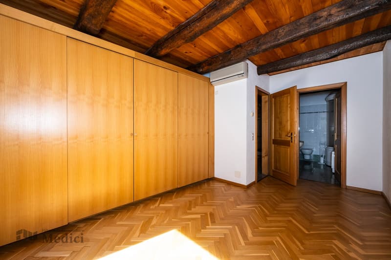 large wooden wardrobes, white walls, wooden parquet flooring, large windows, AC unit, wooden doors