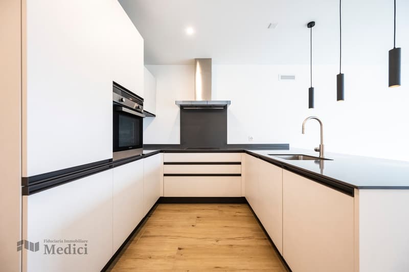 modern design, white cabinets, black countertops, stainless steel appliances, wooden floor